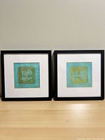 Pair of framed prints side by side