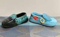 Both ceramic moccasins side by side showing glaze colors and labels