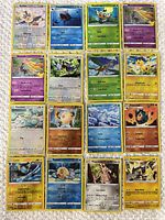 Front view of all 16 Pokémon cards laid out in 4×4 grid
