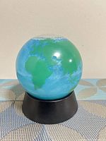 front view showing Africa and Europe on blue water globe with black base