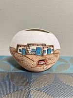 Front view showing pueblo scene and artist mark