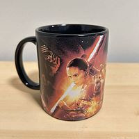 Left side view showing Kylo Ren, Rey and lightsaber artwork on mug