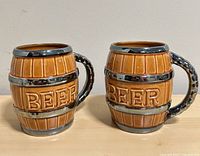 Front view of both ceramic barrel beer mugs