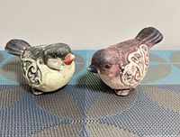 Both bird figurines side by side
