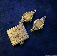 All three Bulova watch movements and cases displayed on blue surface