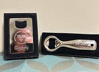 Both bottle openers in boxes, showing overall appearance