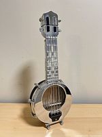 Front view of chrome-plated miniature banjo decanter