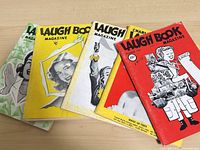 Front view of all five magazines fanned out showing covers