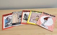 All five Laugh Book magazines spread out on table
