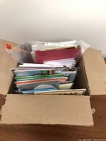 Open box showing vertical stack of many greeting cards