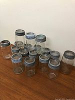 Group shot of all 15 Crown glass jars stacked on table