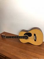 Full guitar resting on surface showing overall condition