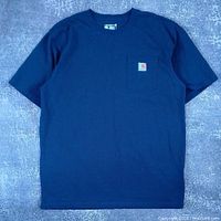 Front view of deep blue Carhartt short sleeve tee with chest pocket and logo patch