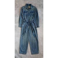 Full view of blue denim jumpsuit laid flat