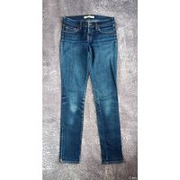 Full front view of blue slim-fit jeans laid flat