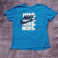 Full front view of blue Nike graphic T-shirt