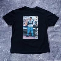 Full front view of black Snoop Dogg graphic t-shirt laid flat