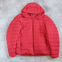 Full view of red hooded puffer parka front side