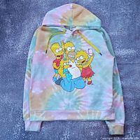 Full view of hoodie front showing tie-dye pattern, hood, kangaroo pocket