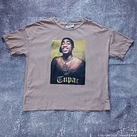 Full front view of brown Tupac graphic T-shirt laid flat