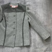 Front view of jacket showing pattern, panels, buttons