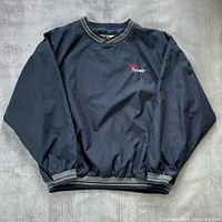 Front view of dark blue pullover windbreaker with ribbed trim