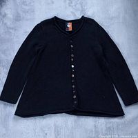 Full view of black button-front flare top