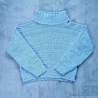 Full front view of light purple knit turtleneck sweater laid flat