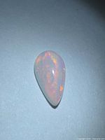 Pear cabochon opal face-up showing play of color