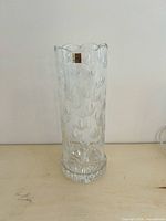 Tall crystal cylinder with scalloped rim and floral cut pattern