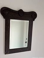 Front view showing entire mirror, frame and bevelled glass