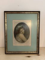 Framed artwork showing full piece in metallic frame and teal mat