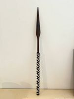 Full spear front view against wall
