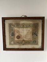 Full view of framed certificate hanging on wall