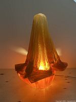 Lamp illuminated showing warm glow and sculptural form