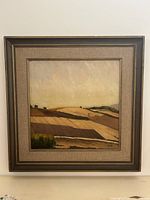 Frontal view of framed landscape painting