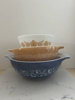 Stacked view of three Pyrex bowls showing colors and patterns