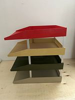 Left side view showing four coloured trays and metal supports