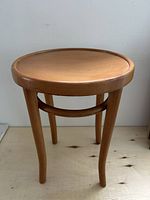 Front view of bentwood stool showing seat and legs