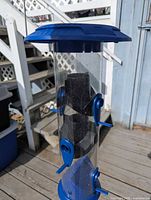 Blue plastic tube seed feeder