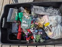 Plastic tote showing varied Christmas decorations inside