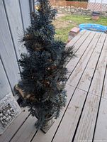 Full view of pre-lit urn-based Christmas tree