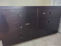 Front view showing six drawers and knobs