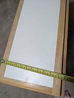 tape measure showing folded top width about 13 inches