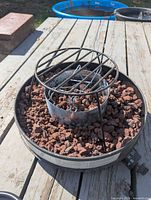 Campfire open showing burner, grate and lava rocks