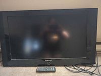 Front view of Samsung LCD TV with remote and cable
