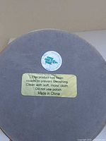bottom label on brass candle holder indicating PartyLite and care instructions