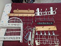 Overview of all racks, shelf, hooks laid out on bed