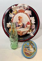 Front view of all three items: large Hilda tray, tip tray, green bottle