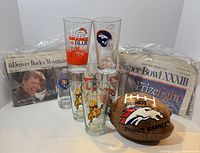 Full lot showing 8 tumblers, two newspaper bundles, painted coconut
